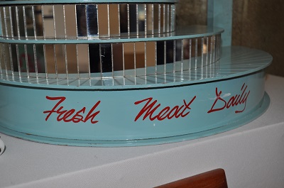 Painting sign 'Fresh Meat Daily'